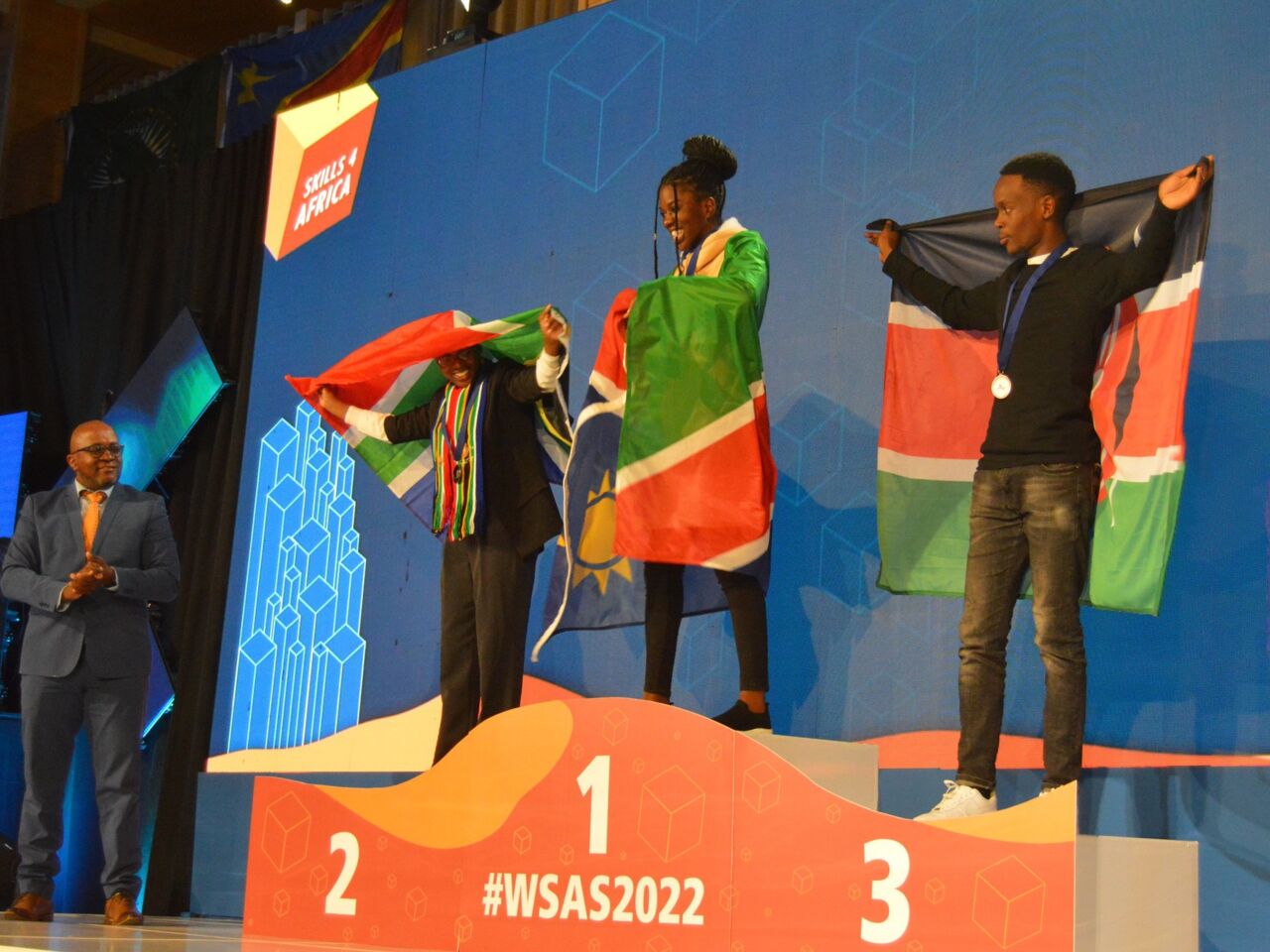 Competitors at WorldSkills Africa Swakopmund 2022 stand on the podium to collect their medals.